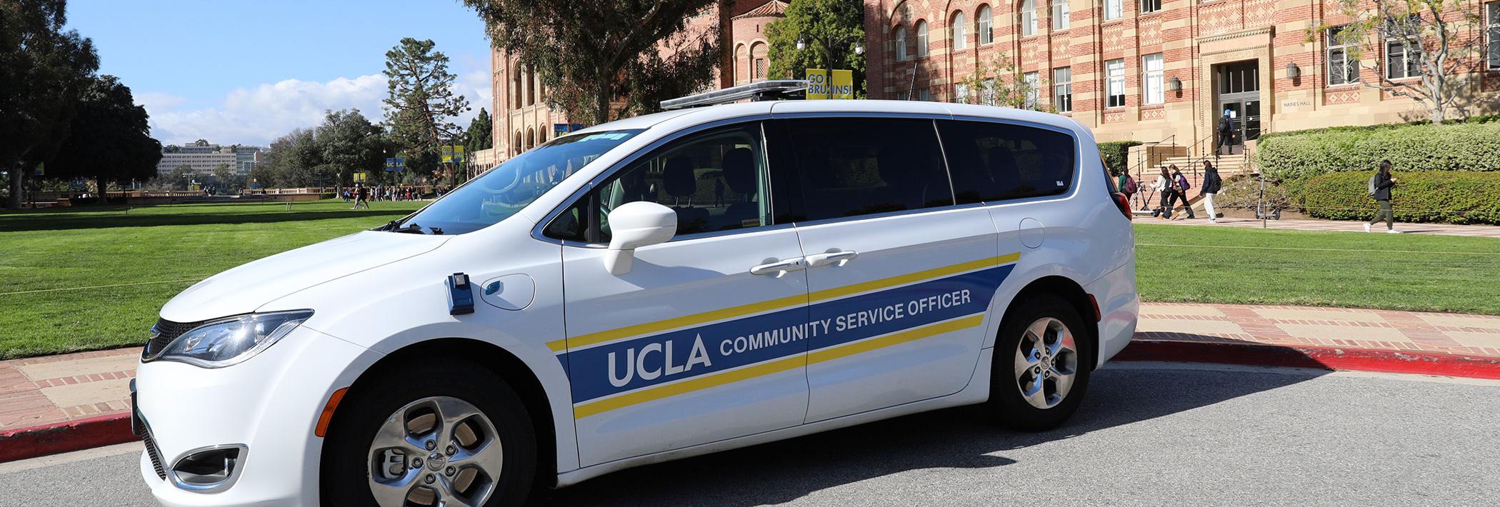 UCLA Police Department Community Service Officer vehicle parked on the campus quad. Royce hall and the hill in the background.